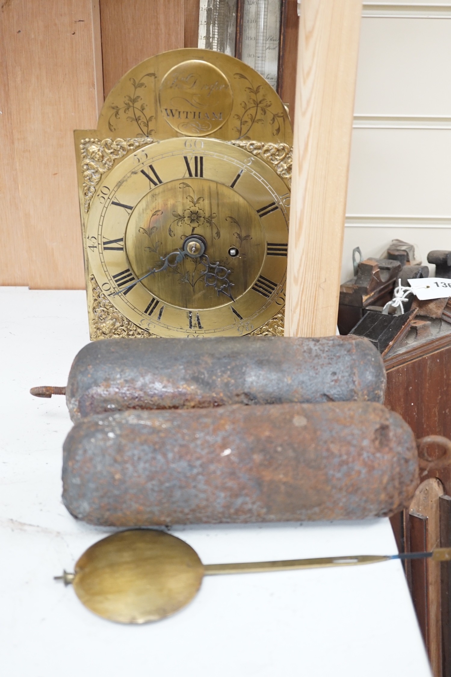 A 19th century bracket timepiece movement, a pair of iron clock weights and three barometer carcasses